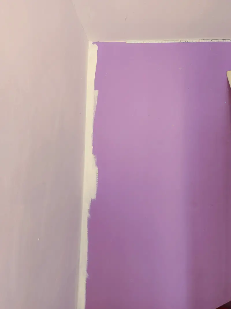 A purple wall - the adjoining wall has been painted white