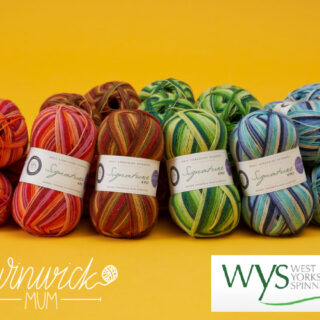 A stack of balls of Signature 4ply from the Winwick Mum Seasons range are gathered together on a mustard-coloured background.