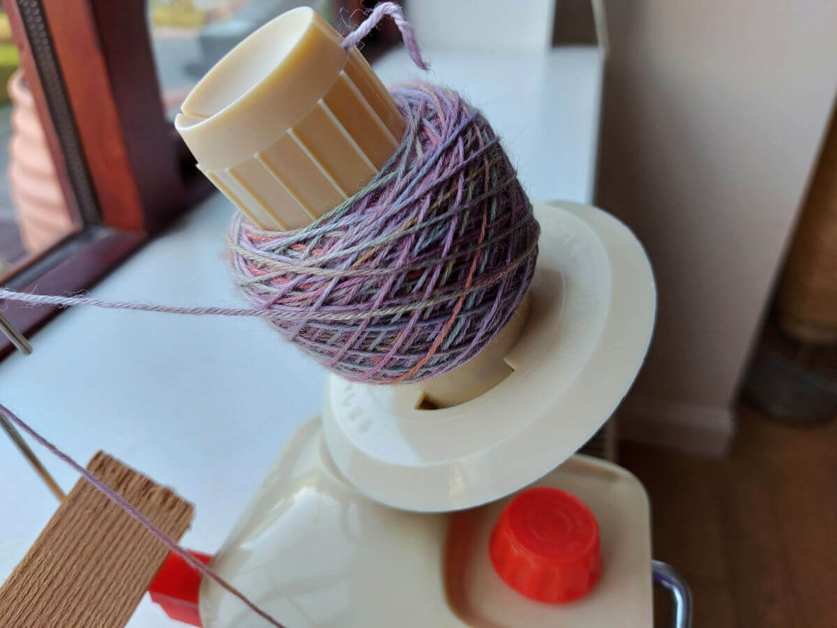 A small yarn cake on the winder.