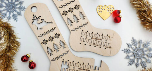 A flatlay of adjustable wooden sock blockers surrounded by Christmas stars, red glass baubles, gold tinsel and a tiny ceramic reindeer.