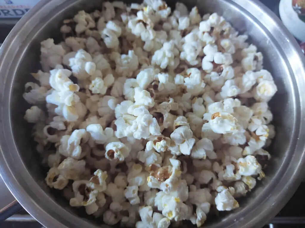 Fluffy white popcorn filling the pan