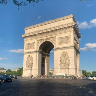 A large square moment with an arch in the middle against a blue sky