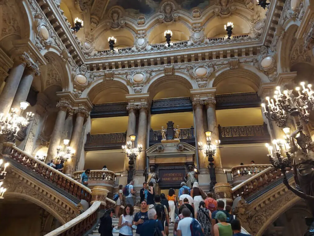 A grand staircase leading up to the upper floor. The overwhelming impression is of gold and opulence