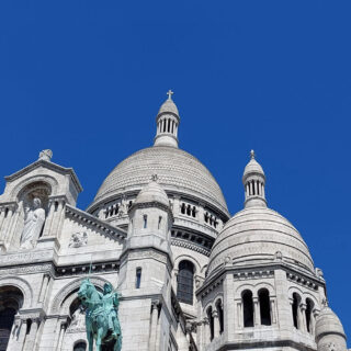 Domed towers stand out against a blue sky