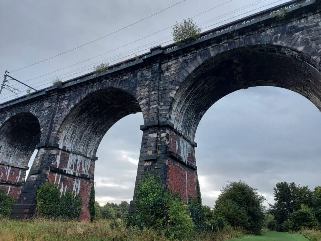 Brick built railway arches against a grey sky