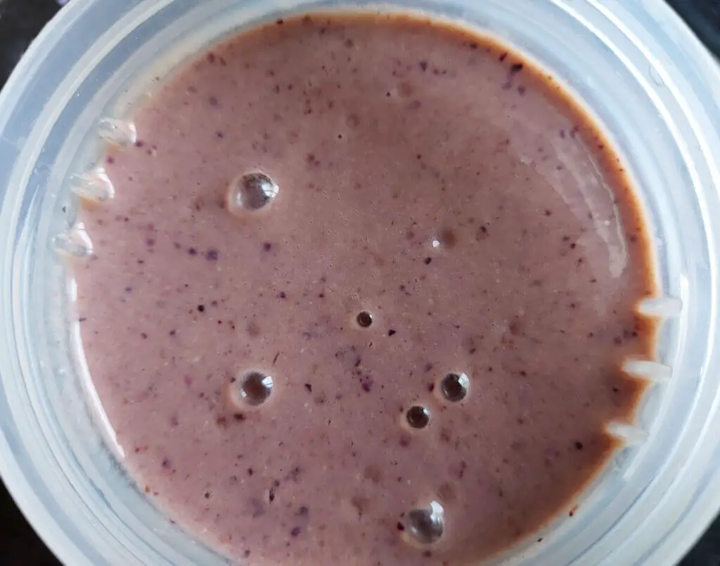 A pink smoothie in a cup