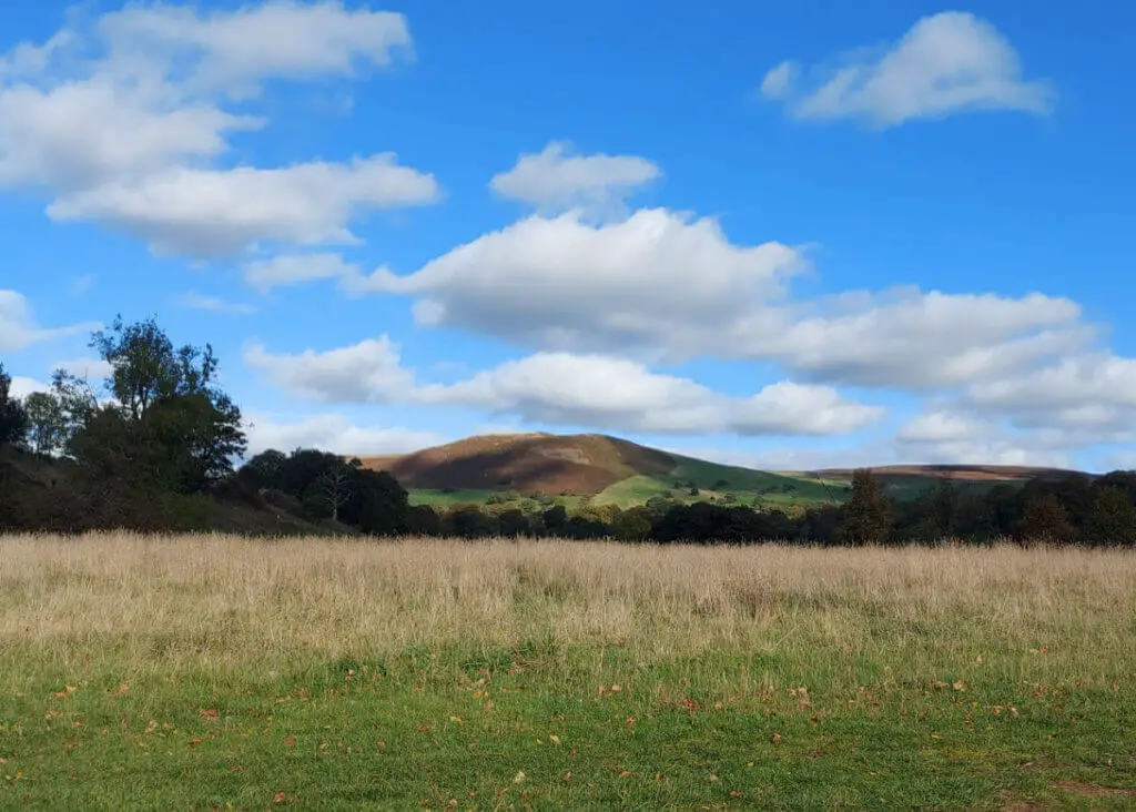 A closer view of a hill with shadows created by clouds