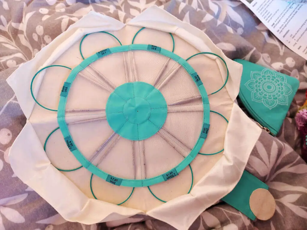 A fabric case containing knitting needles which looks a bit like a flower when it is opened up