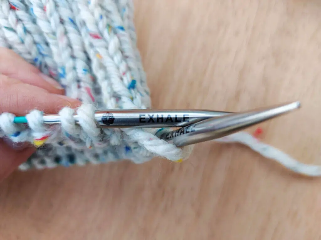 The word "exhale" is stamped on a metal needle tip