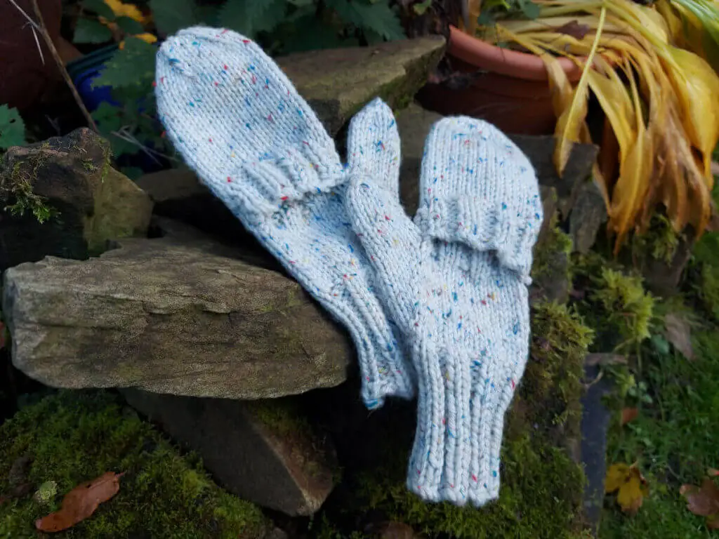 A pair of mittens lying on rockery stones