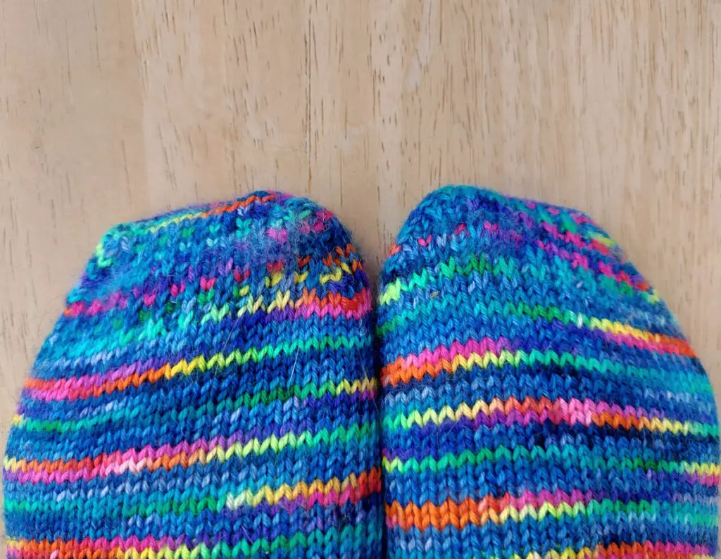 A close up of the toes of a pair of multicoloured socks