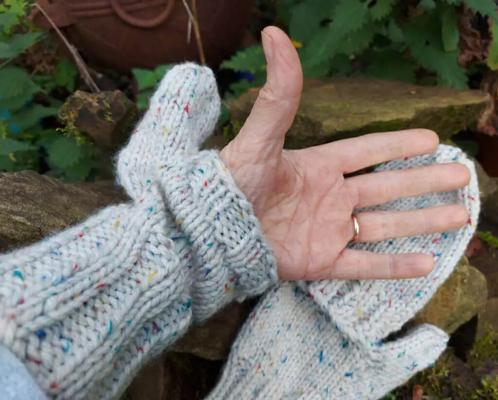 Christine's hand pushed through the split of a Split Mitten to show how it works