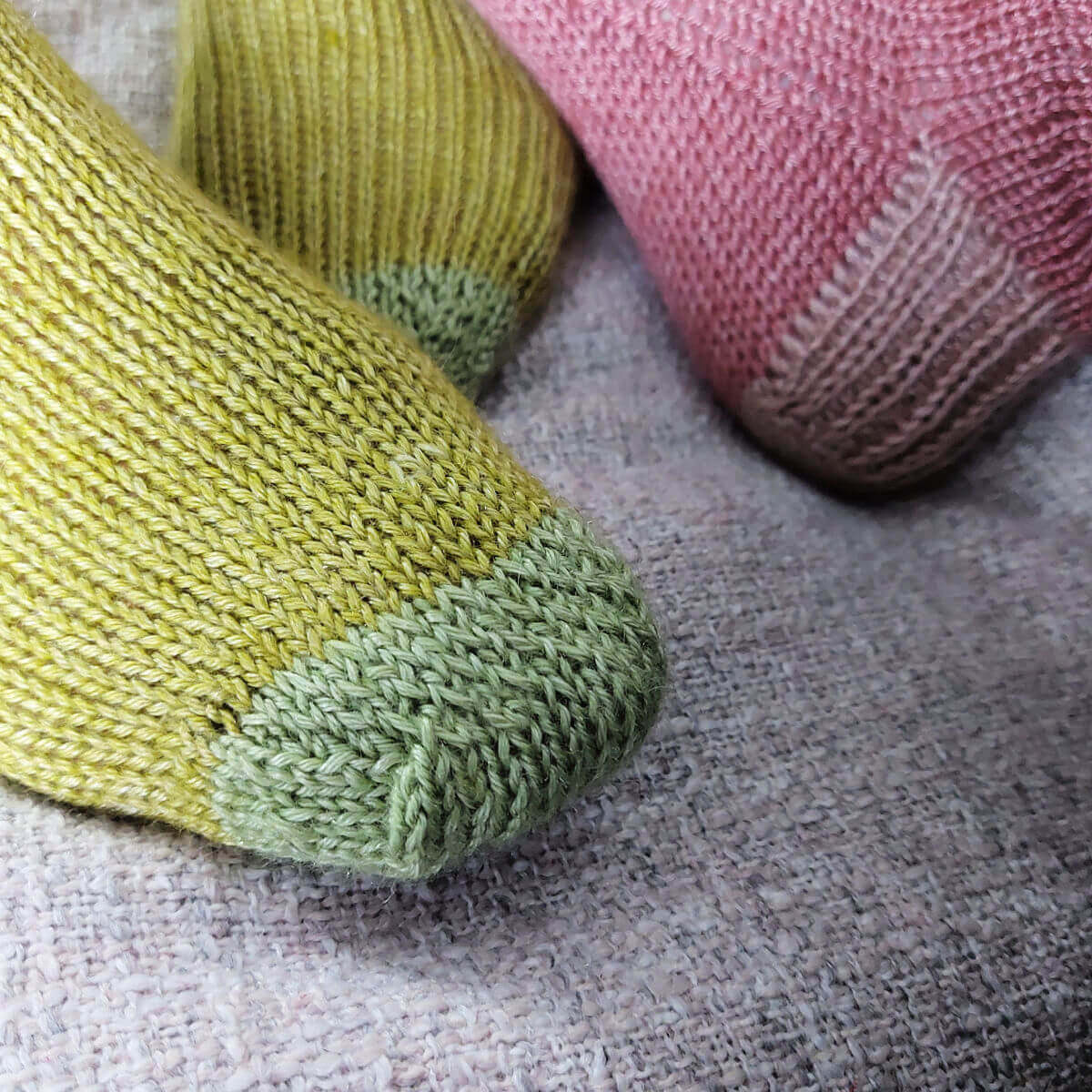 A close up of the toes of a pair of green socks