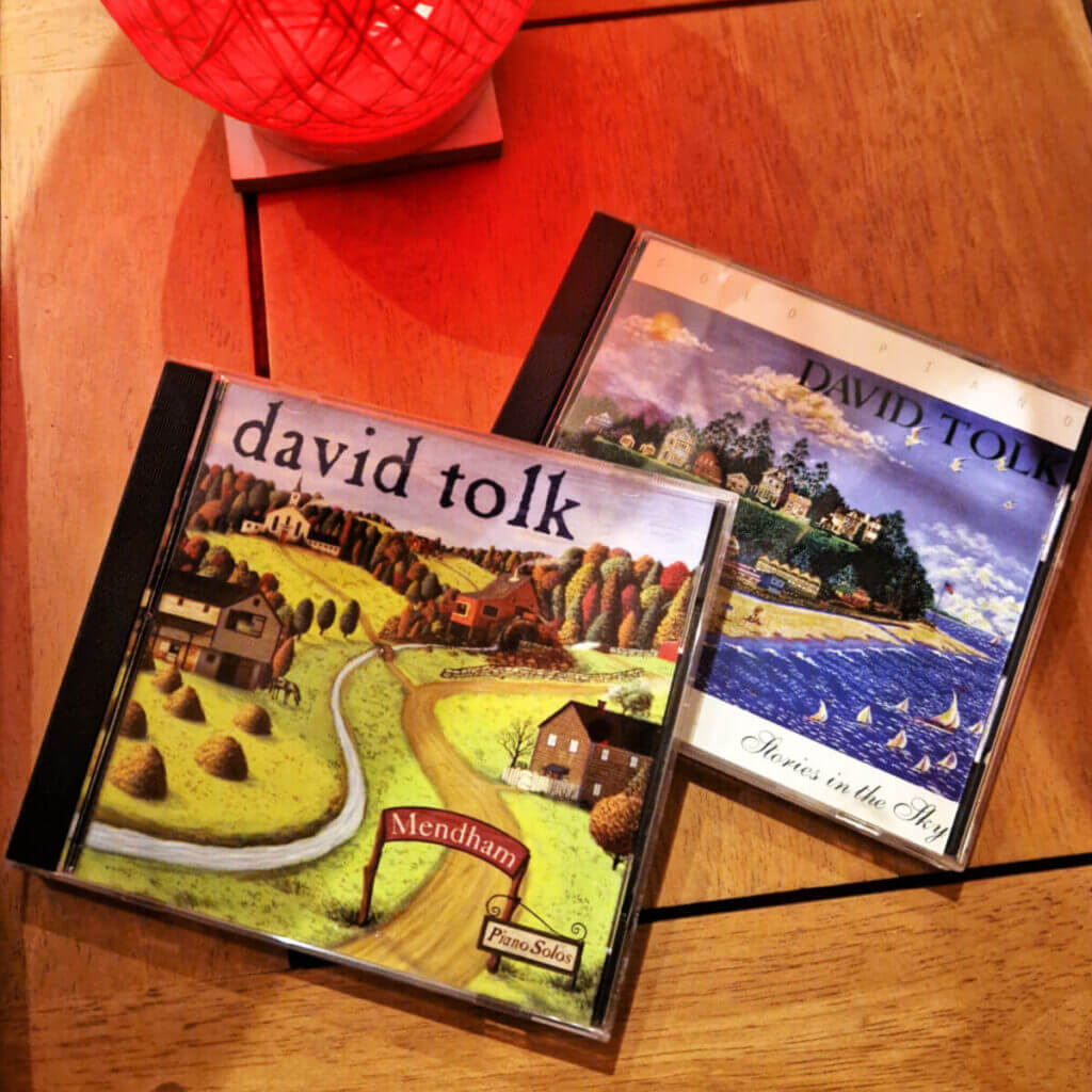 Two CDs on a wooden table