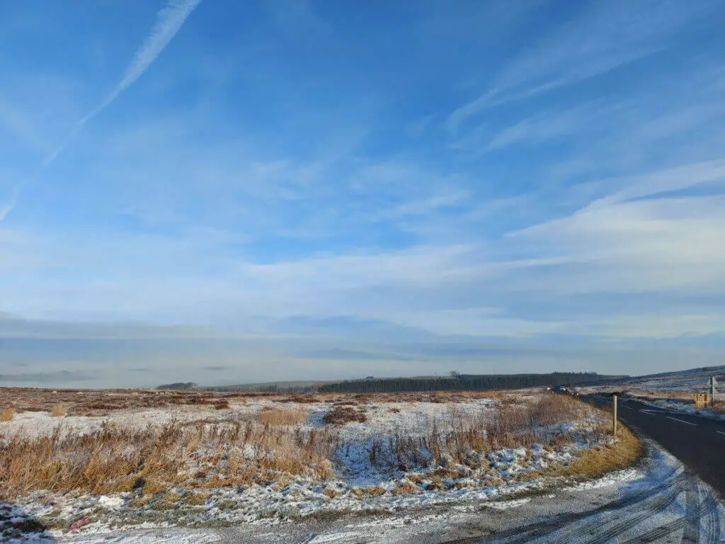 A view across frosty moorland to Skipton, which is shrouded in fog