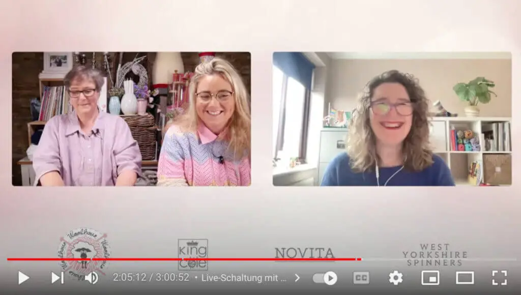 Christine is smiling into the camera on a video call.  To the left is a shot of two ladies wearing shades of purple to whom Christine is speaking.  Behind Christine is a storage unit containing books, yarn 
