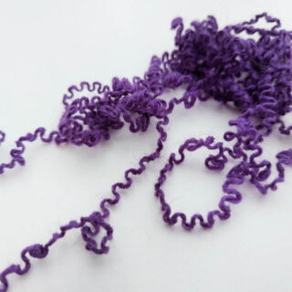 Curly purple yarn - the result of a project being unravelled