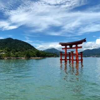 A shrine gate on a lake. The gate looks like it is floating on the water