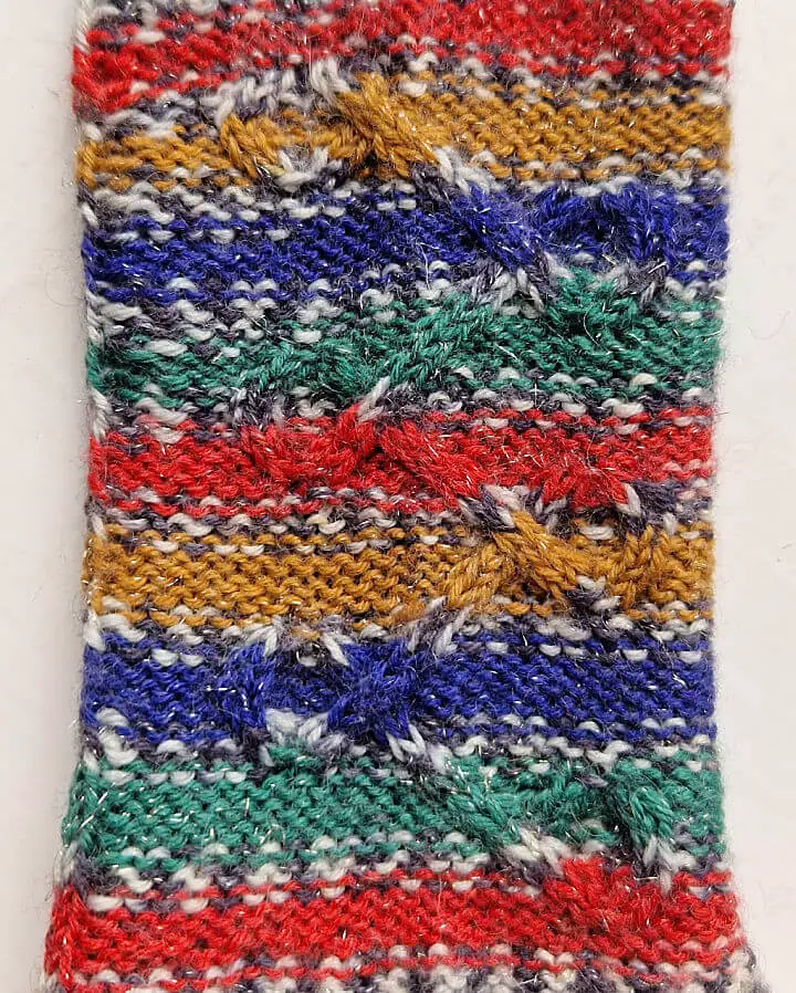 A close up of the cable pattern on a handknitted sock