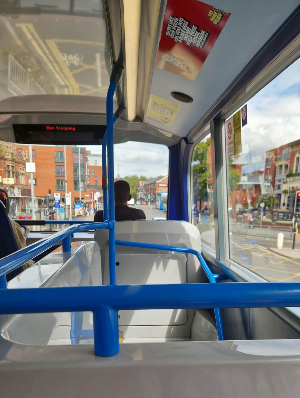 View across a double decker bus from a seat above the stairs