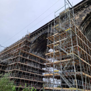 Looking up at brick built arches surrounded by scaffolding