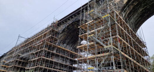 Looking up at brick built arches surrounded by scaffolding