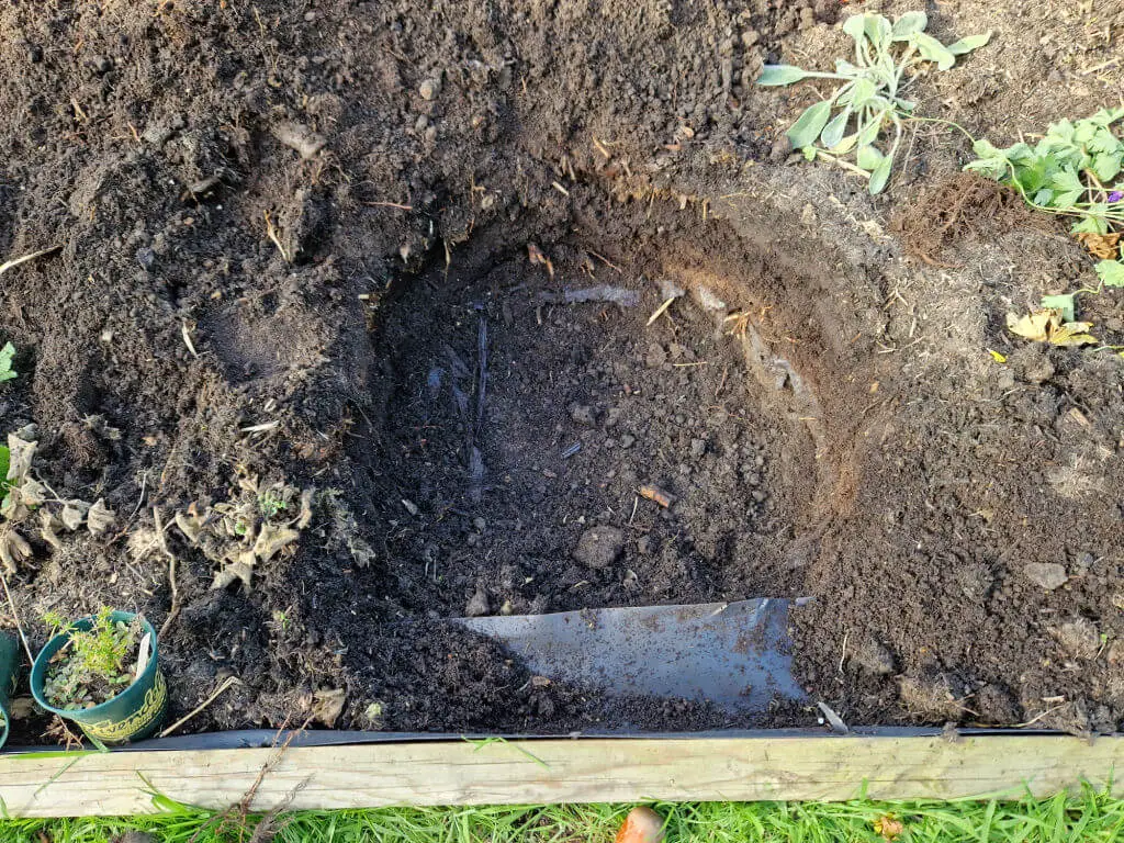 A large hole dug in soil