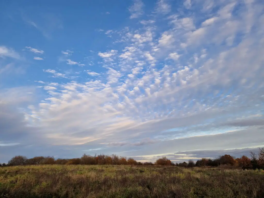 Cloud formations above a meadow