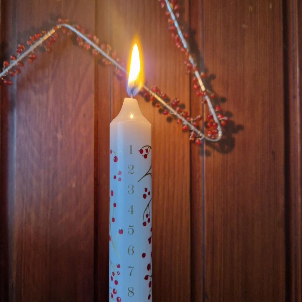 A close up of an Advent candle which has just started burning down the numbers