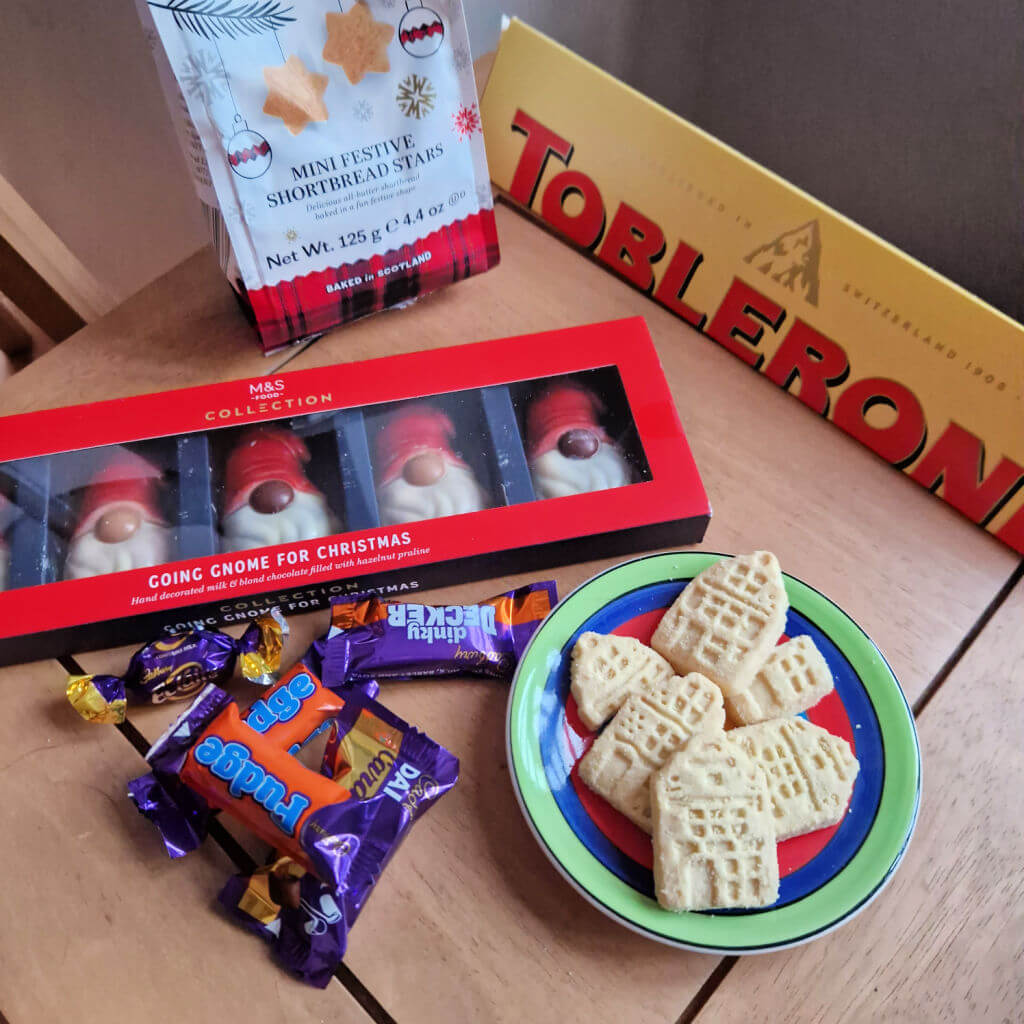 A selection of chocolate and shortbread biscuits on a wooden coffee table