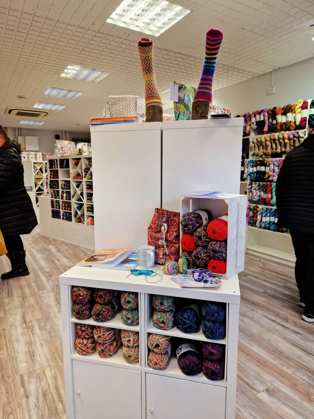 A small display of yarn, hand knitted socks and sock knitting books