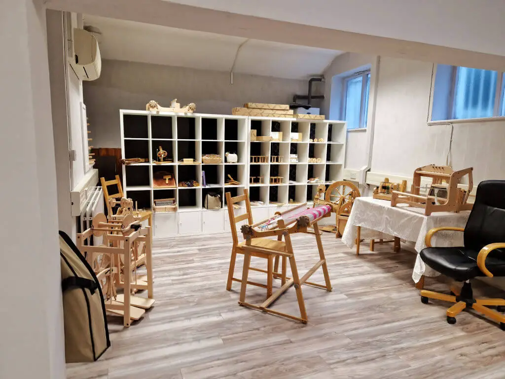 A large space at the back of a yarn shop dedicated to spinning wheels, weaving and their associated accessories