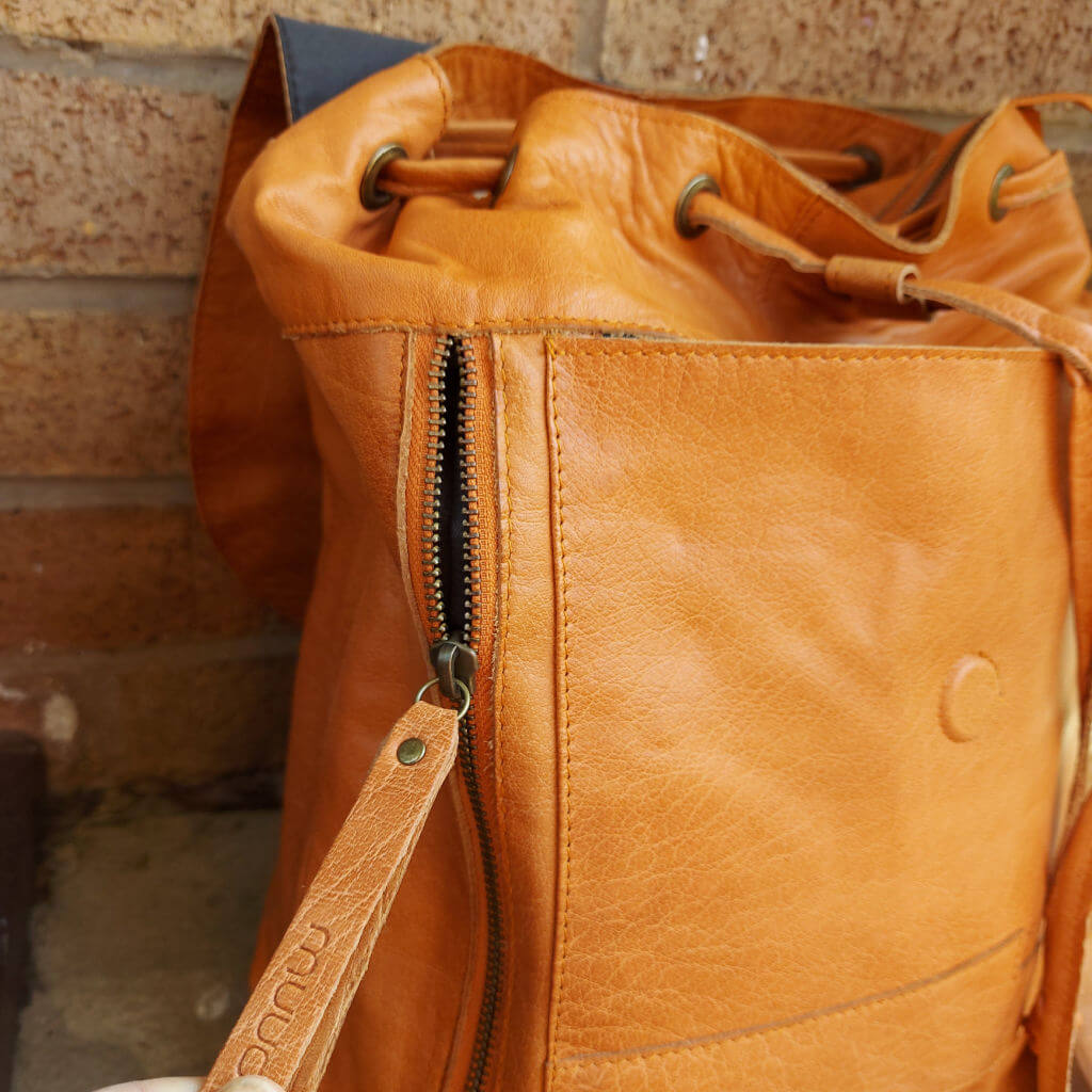 A close up of the side zipped pocket of a Muud Gimo backpack