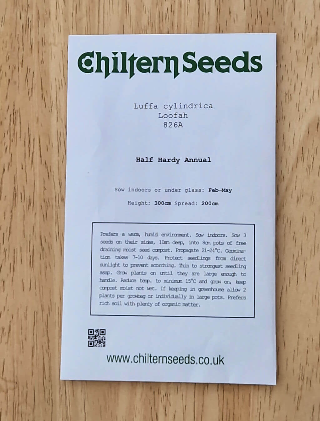 A packet of Luffa seeds on a wooden table