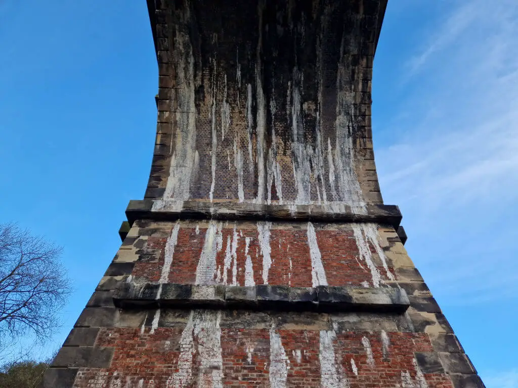 Stone lintels damaged by lime dripping from the arched roof of a railway viaduct