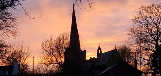 Silhouette outline of Winwick Church against a sunset sky