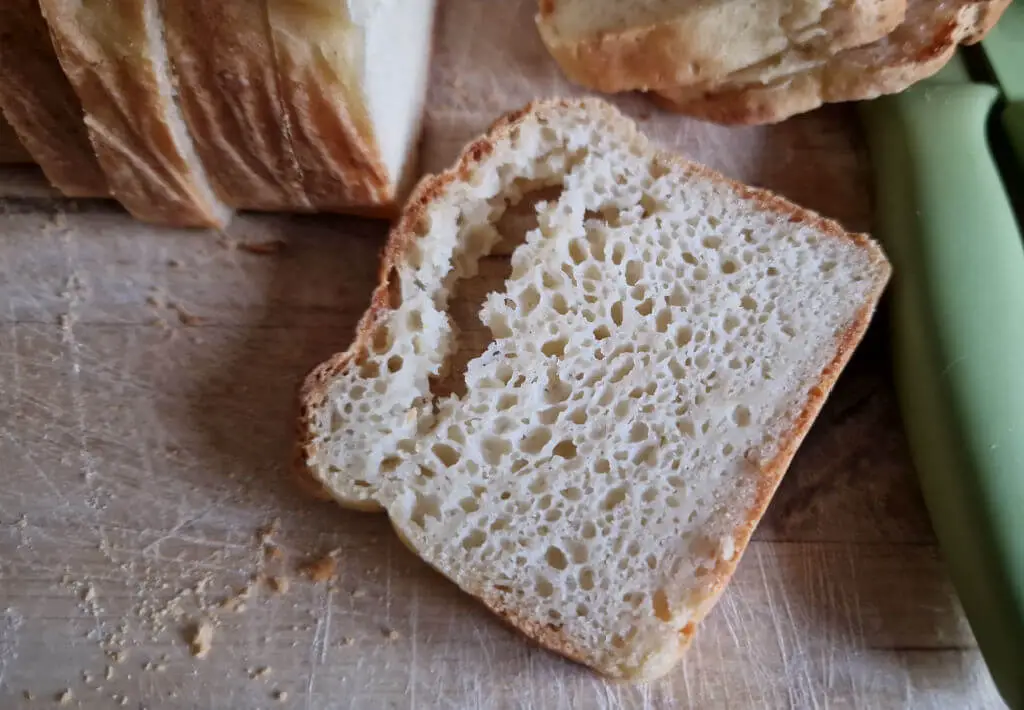 A slice of bread on a wooden bread board