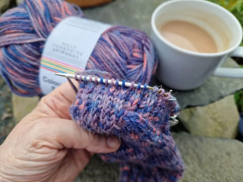 A close-up of a reinforced sole on a hand knitted sock