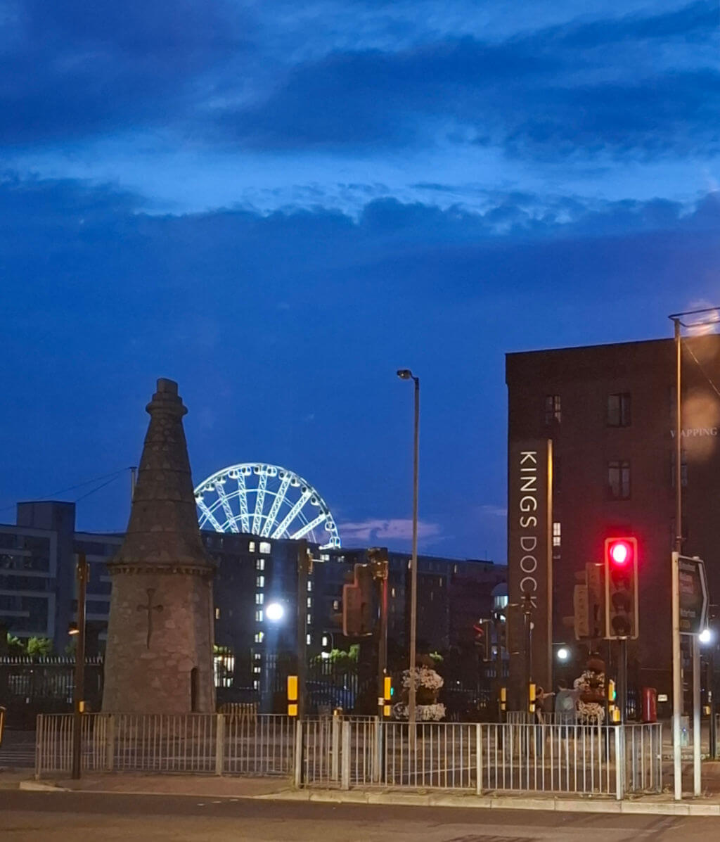 The Liverpool Eye ferris wheel lit up against a blue night sky