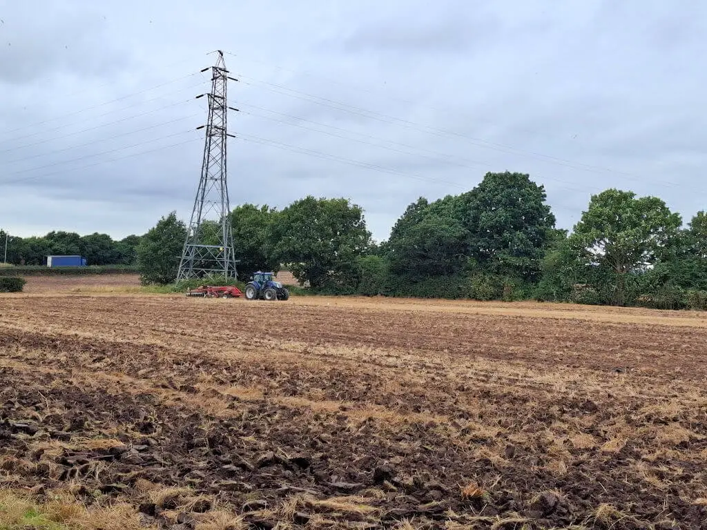 A tractor in a partly ploughed field