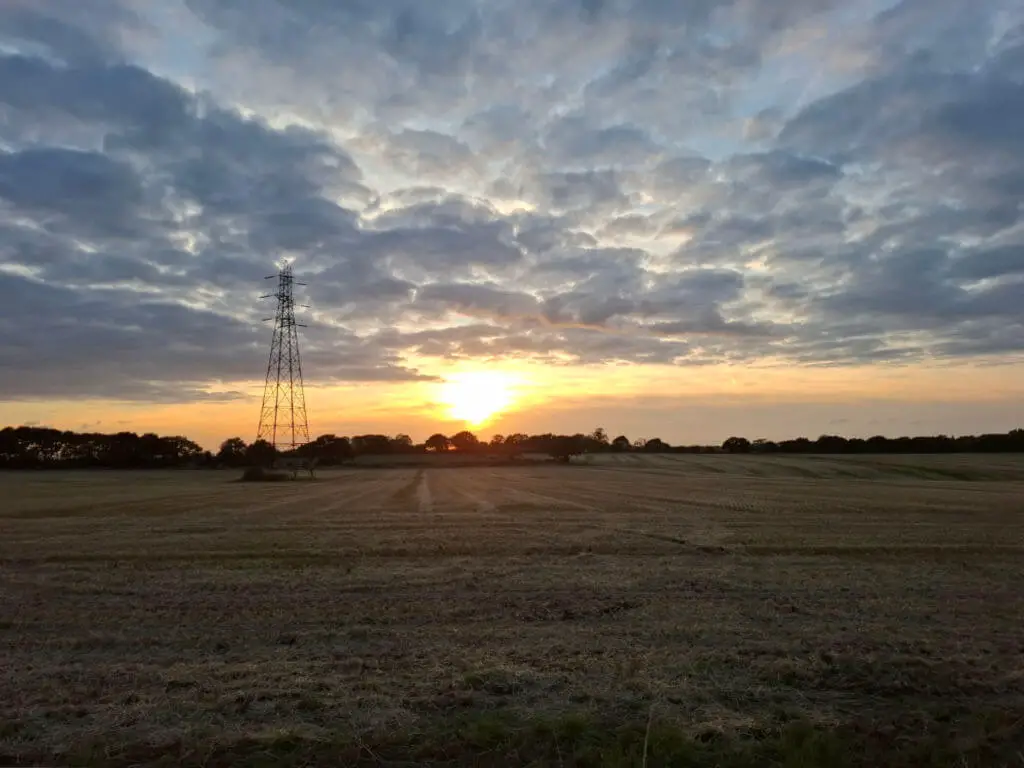 A sunset over a field of stubble