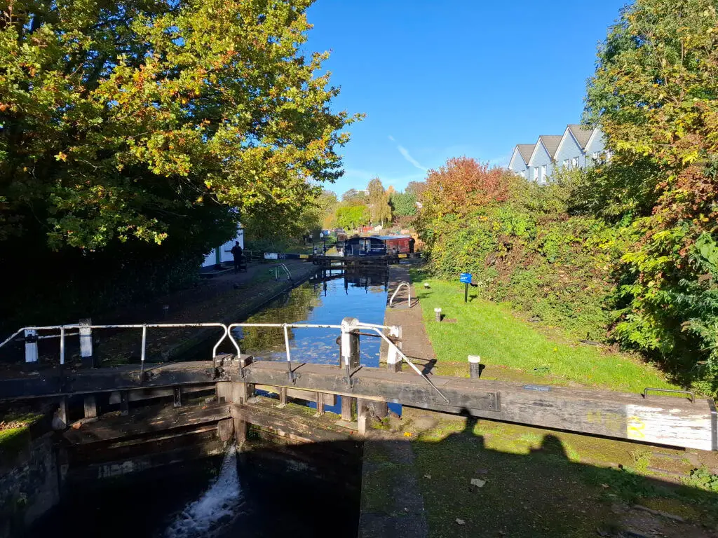 A narrowboat at the far end of a canal lock