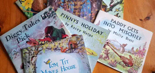 A selection of children's story books lying on a wooden table