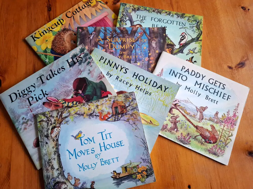 A selection of children's story books lying on a wooden table