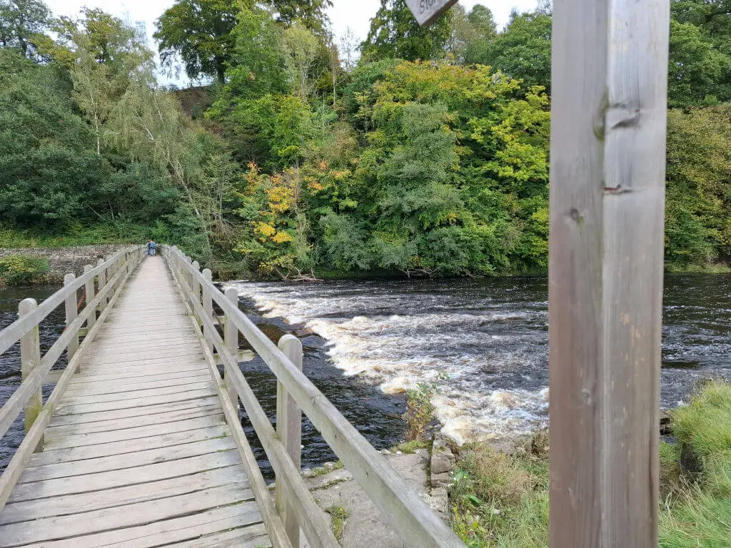 A wooden footbridge across a river