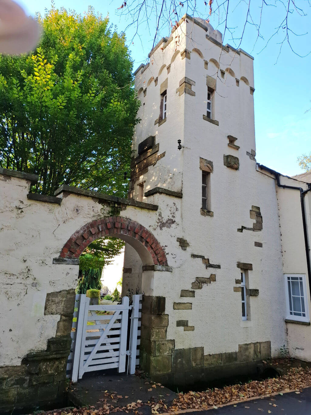 A square stone house with a tower