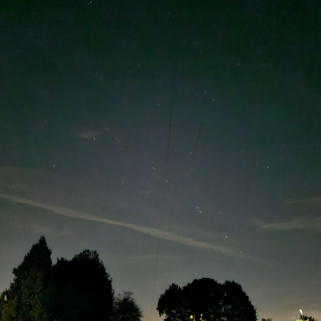 A row of Starlink satellites in the night sky