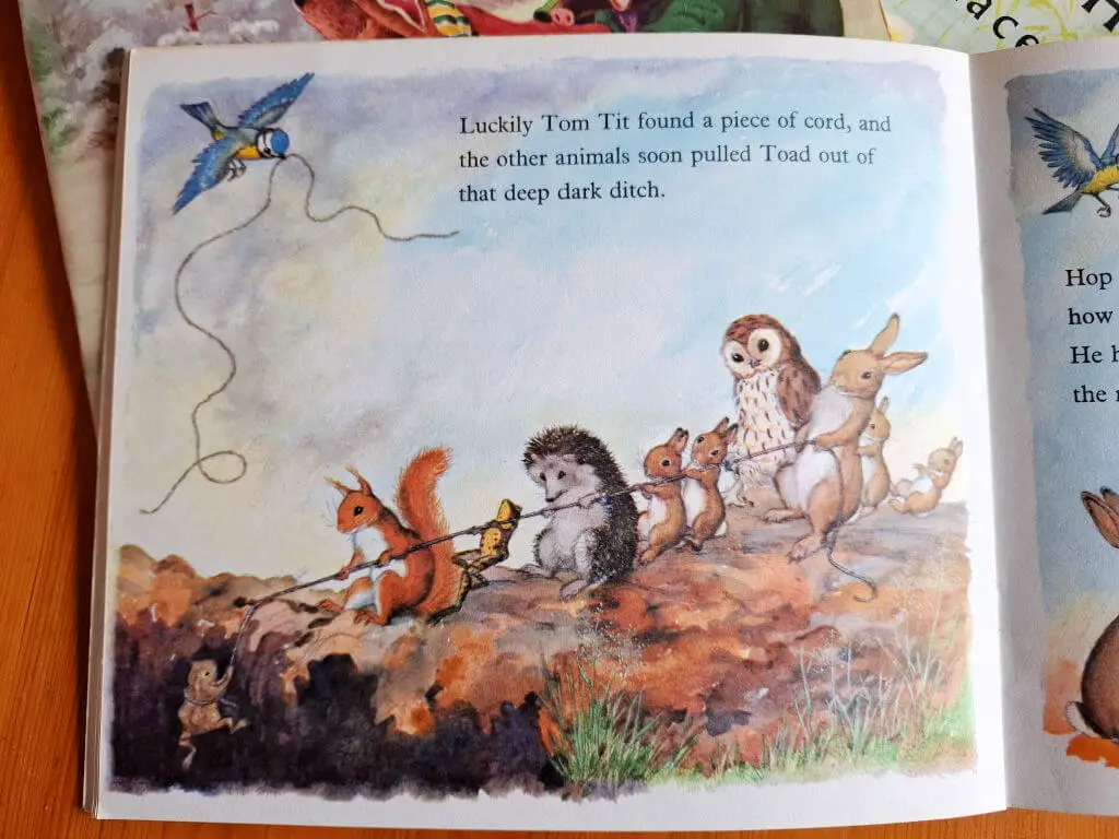 A page from a story book showing animals helping to pull a toad out of a big hole