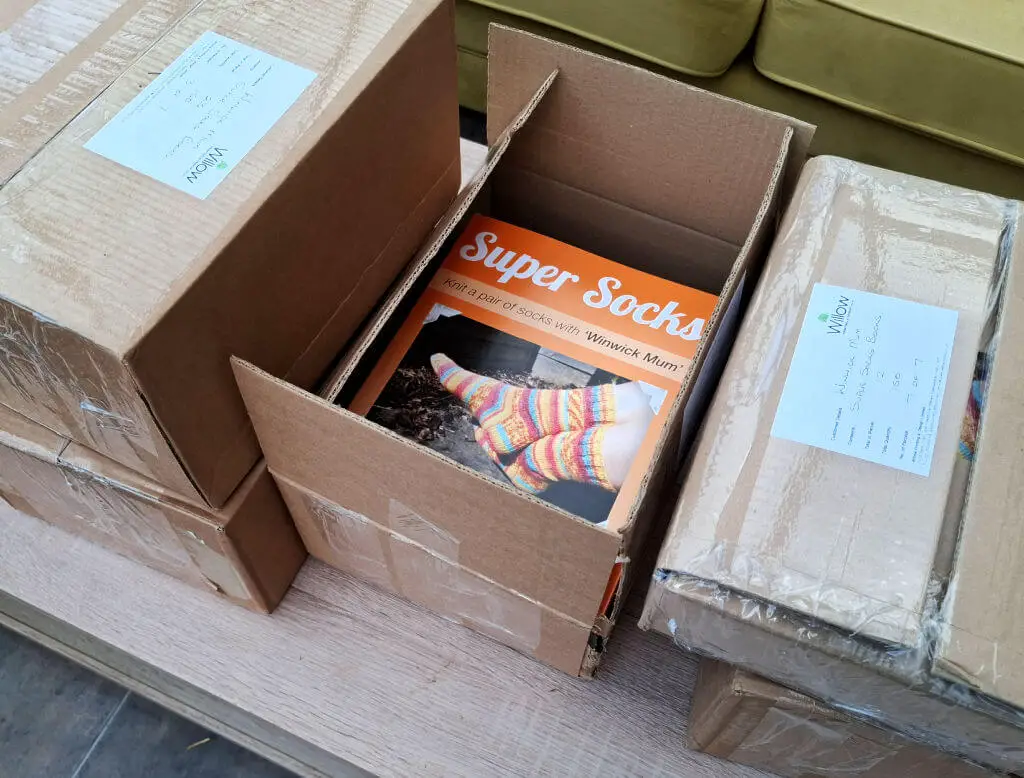 Orange Super Socks books inside a cardboard box as part of a delivery
