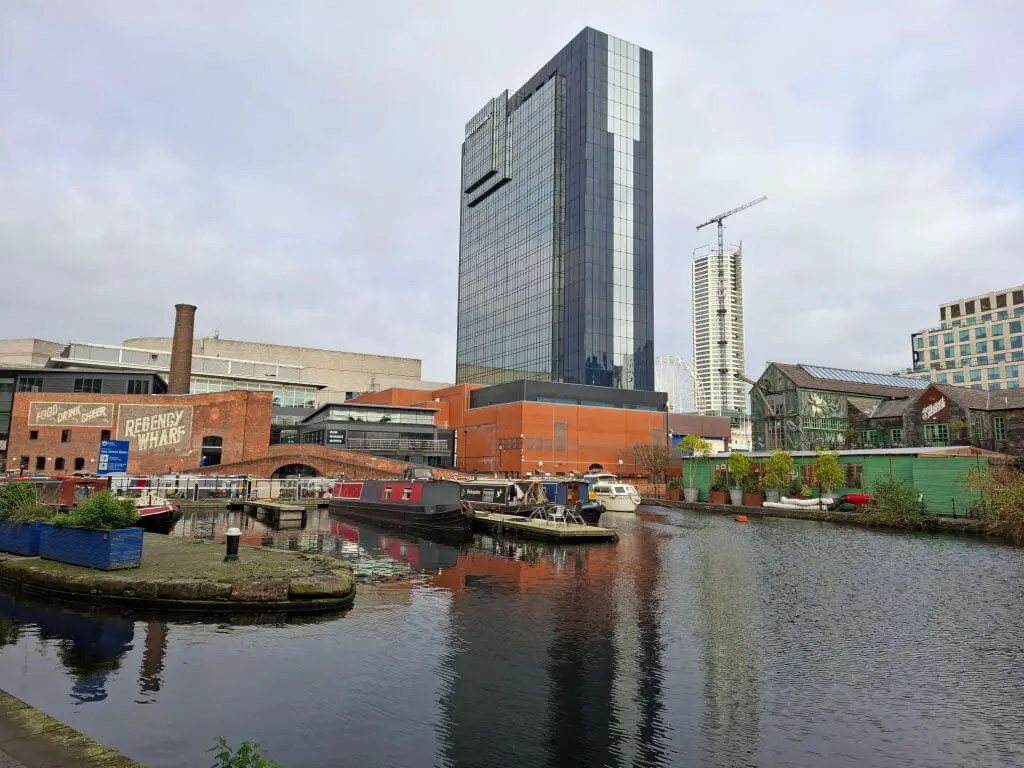 Canal boats moored in next to high rise office blocks